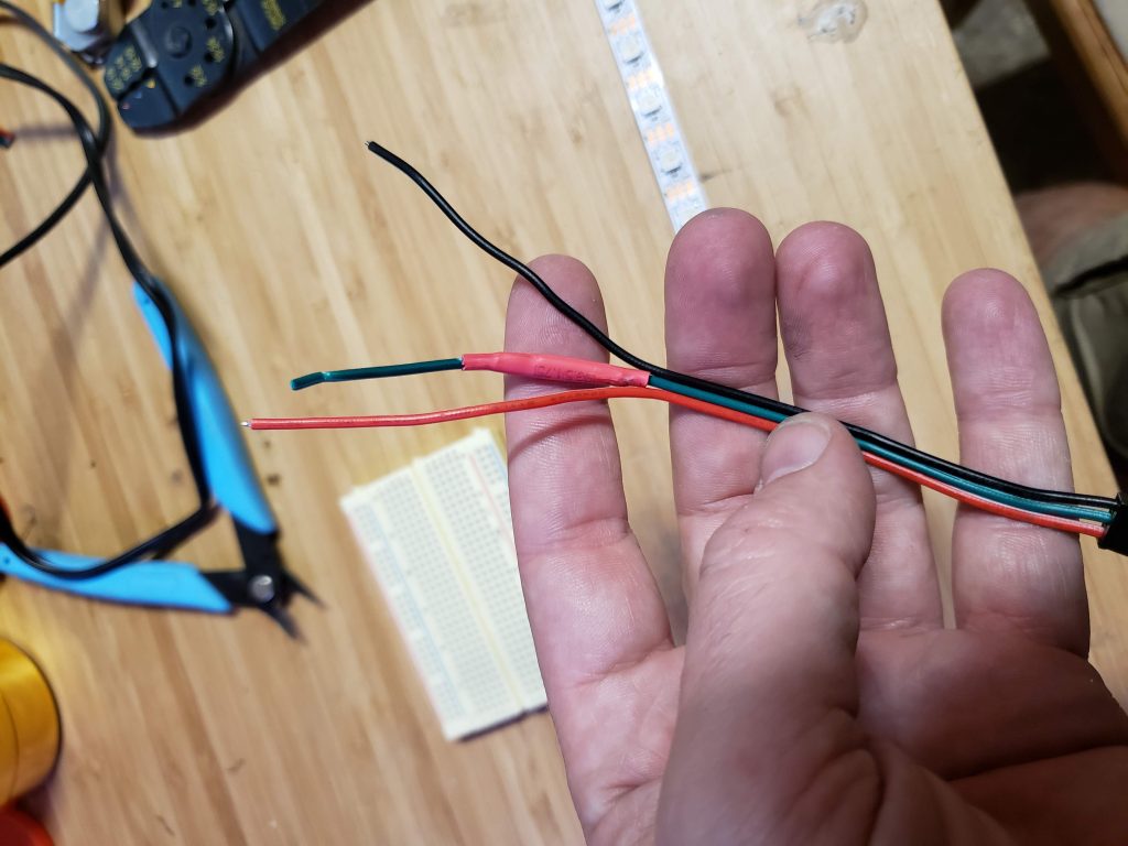 A resistor soldered onto a wire and shrink wrapped in red