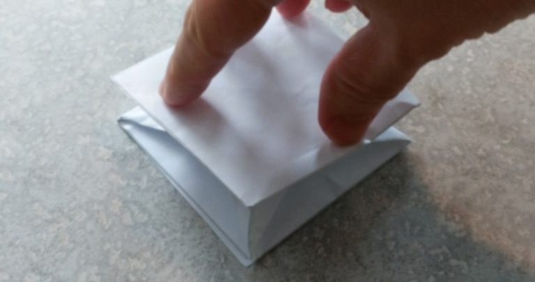 Paper Cube Being Crushed