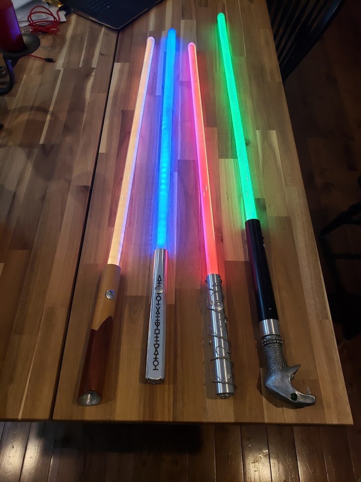 four lightsabers with hilts modeled on wands from the harry potter movies